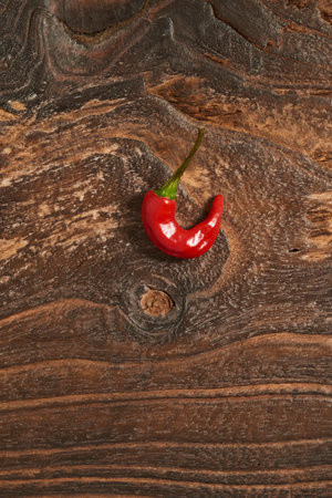 Red hot chili pepper on old wooden background.の写真素材