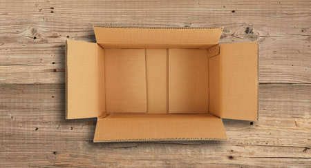 A open paper box on wood floor.の写真素材