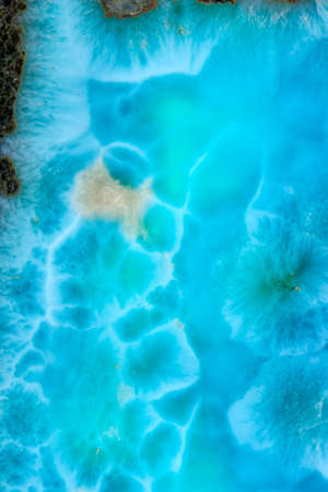 Luxury Larimar raw mineral crystal background of texture material.