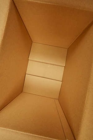 Cardboard paper cube open, close-up studio shot.