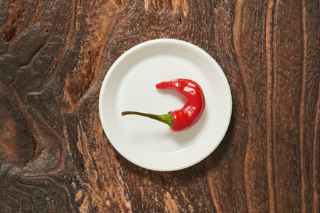 Red hot chili pepper on old wooden background.