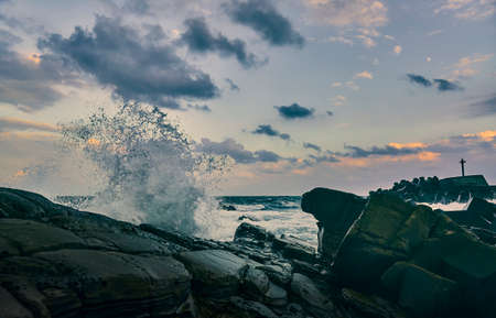 Sea wave with orange sunset sky in Pacific Ocean.
