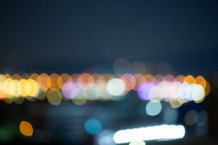 Night bokeh light, blur background of cityscape, blue color toned, abstract.の写真素材