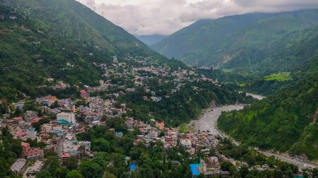 A village overlooking a river in the Himalayas
