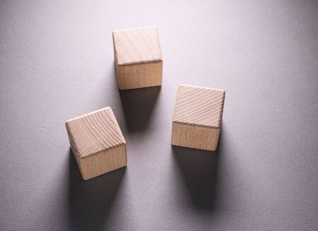 Wooden Geometric Shapes Cube on a paper background , This can use for past your wordsの写真素材