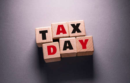 Tax day Word Written on Wooden Cubesの写真素材