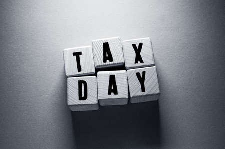Tax Day Word Written on Wooden Cubesの写真素材