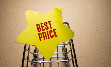 Business and finance concept. On the table is a shopping cart and the inscription - BEST PRICEの写真素材