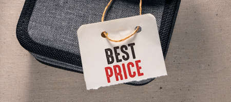 Business and finance concept. On a gray background lies a bag with the inscription - BEST PRICEの写真素材