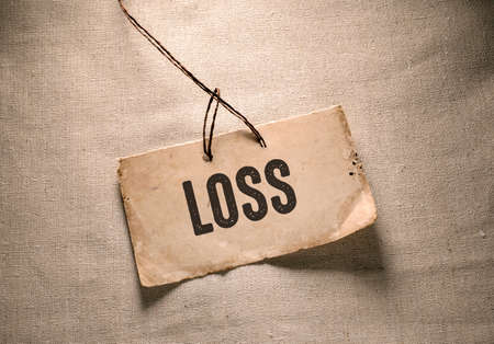 closeup of a piece of paper with the word loss on it