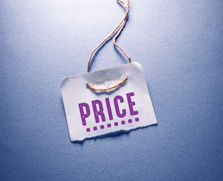 Price tag on a blue background. Business concept. Selective focus.の写真素材