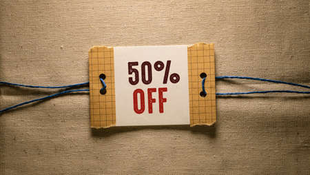 50 percent off text on a piece of paper attached to a ropeの写真素材