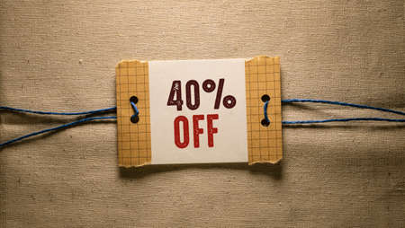 40 percent off sign on a piece of paper on a linen backgroundの写真素材
