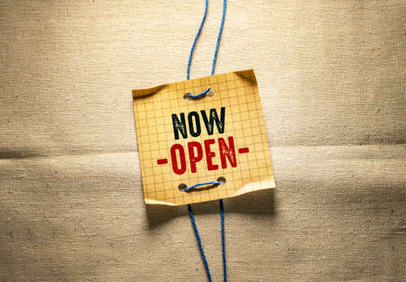 Now open sign on a piece of paper with rope. Business conceptの写真素材