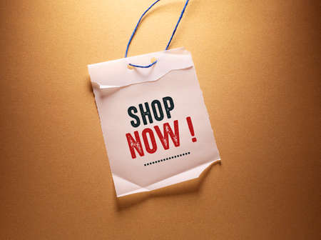 Shopping bag with text Shop Now on brown background, top viewの写真素材