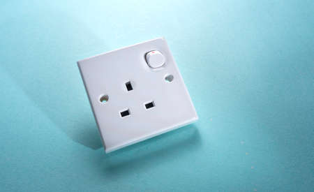 Electrical socket on a blue background. Power supply. Selective focus.