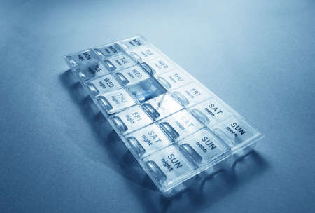 Close up of pills and tablets in treatment routine boxの写真素材