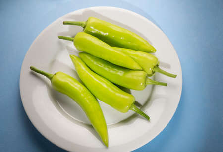 Close up of frsh green chilli peppers on tabelの写真素材