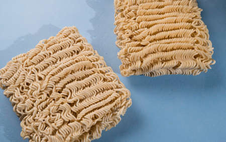 Instant noodles isolated on colour backgroundの写真素材