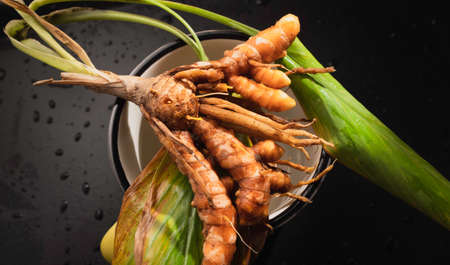 Close up of fresh healthy turmeric in slicesの写真素材
