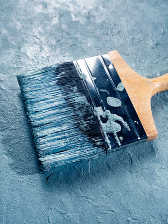 Close up of paint brush on textured wallの写真素材