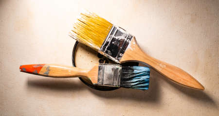 Close up of paint brush on textured wall