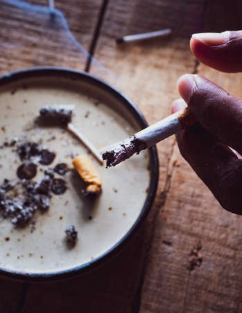 Closeup of discarded cigarette butts with ashの写真素材