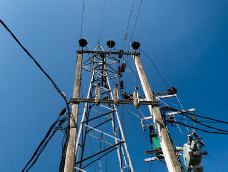 Electricity pylon with blue sky background. High voltage post.の写真素材
