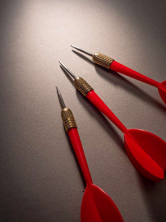Red darts on a gray background, close-up, copy spaceの写真素材