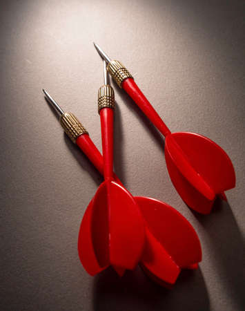 Red darts on a dark background. Business concept. Copy space.の写真素材