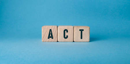 On a light blue background, wooden cubes with the letters Act.の写真素材