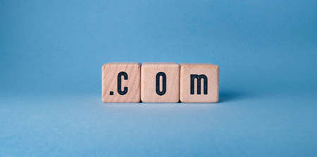 COM - acronym on cubes on a blue background. Business conceptの写真素材