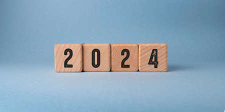 2022 new year concept with wooden cubes on a blue background.の写真素材