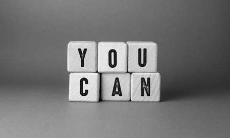 The word You Can written on wooden cubes. Gray background. Business concept.の写真素材