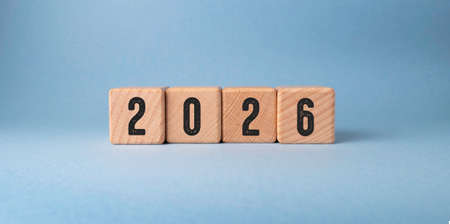2026 new year on wooden cubes on a blue background.の写真素材