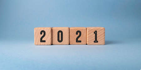 2021 new year concept. Wooden cubes with numbers on a blue background.
