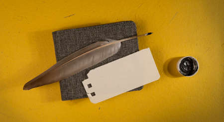 Feather and card on the table with copy space. Top viewの写真素材
