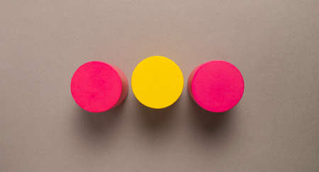 Top view of three colorful round rubber stamps with yellow and red on gray backgroundの写真素材