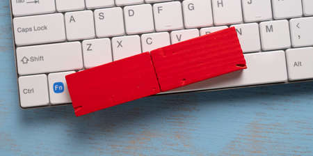 Red torn paper on white computer keyboard with copy space, business conceptの写真素材