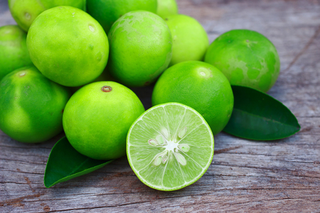 Fresh limes on wooden backgroundの写真素材
