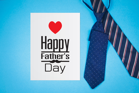 Happy Father's Day text on white sheet with ties on blue paper backgroundの写真素材