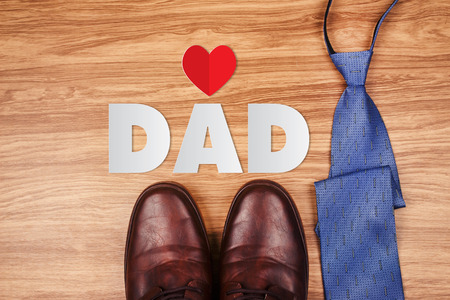 Paper cut of DAD text with old rusty tools and tie on wooden background, Happy Father's Dayの写真素材