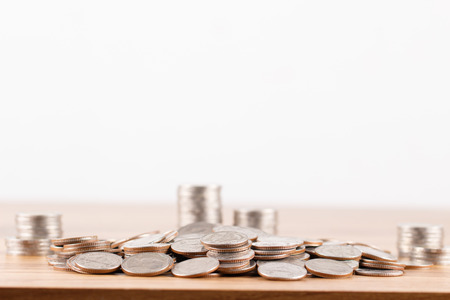 Stack of coins on wooden desk for saving money conceptの写真素材
