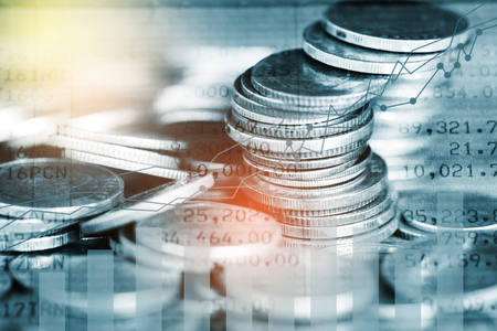 Stack of coins with growing graph for business finance conceptの写真素材