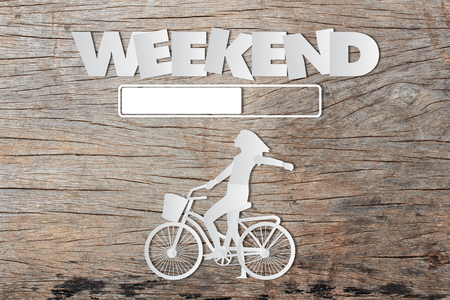 Paper art of WEEKEND loading text on wooden tableの写真素材