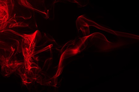 Movement of red smoke on black background