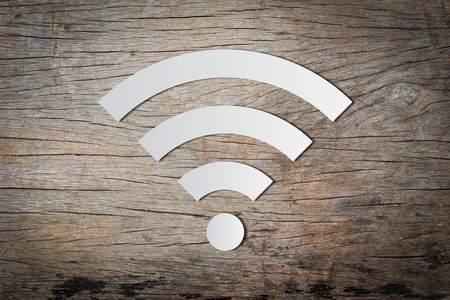 Paper cut of free WiFi icon on wooden backgroundの写真素材
