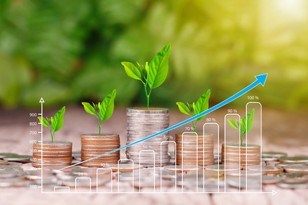 Stack of coins and growing graph for business finance conceptの写真素材