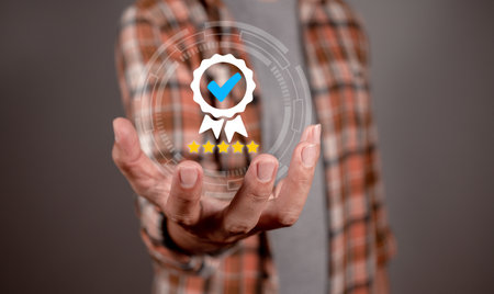 Hand shows the sign of the top service Quality assurance, Guarantee, Standards, ISO certification and standardization concept. Approved badge icon symbol medal award ribbon with 5 starsの写真素材