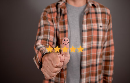 Customer hand with thumb up Positive emotion smiley face icon and five star. Service rating, satisfaction concept.の写真素材